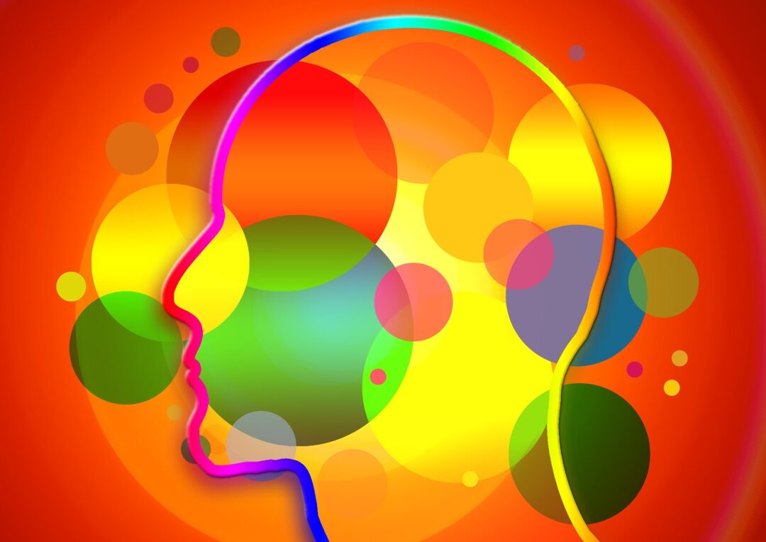 A colorful silhouette of gender-neutral head with very colorful background